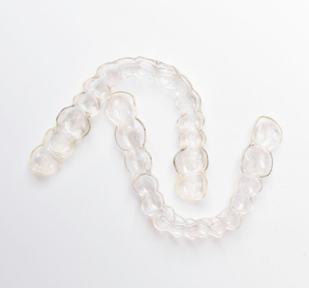 Clear orthodontic aligner retainers on a white background
